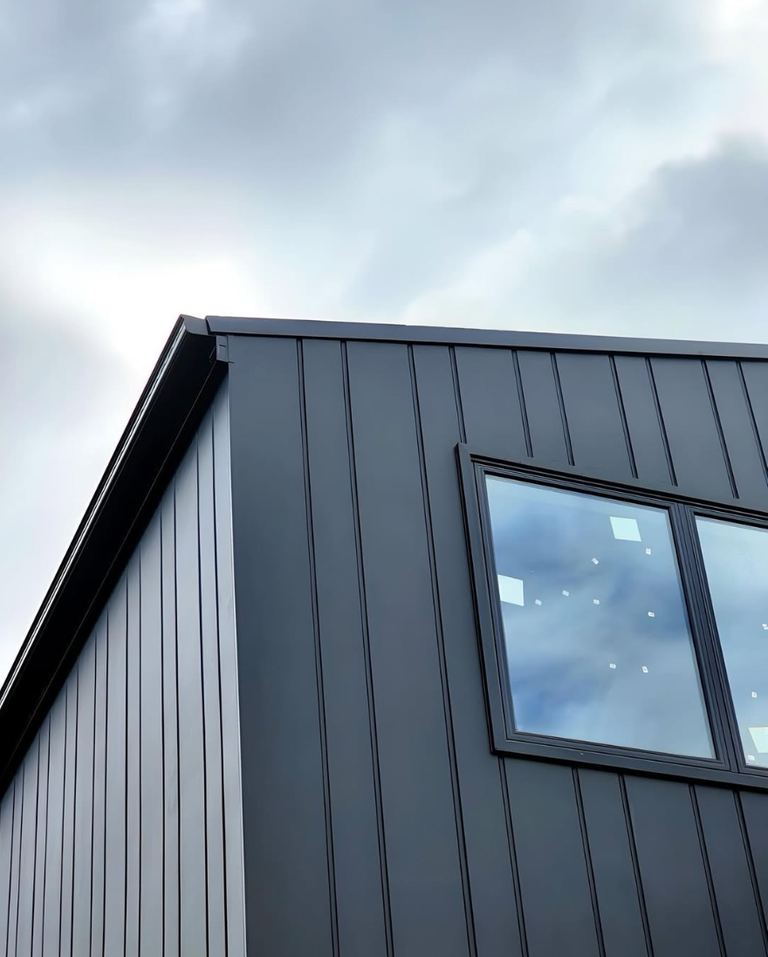 Black James Hardie Oblique cladding with vertical recessed grooves and window detail