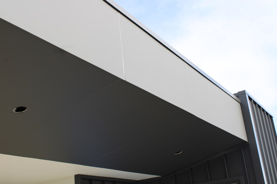Close view of aligned James Hardie Matrix fascia panels above a dark soffit