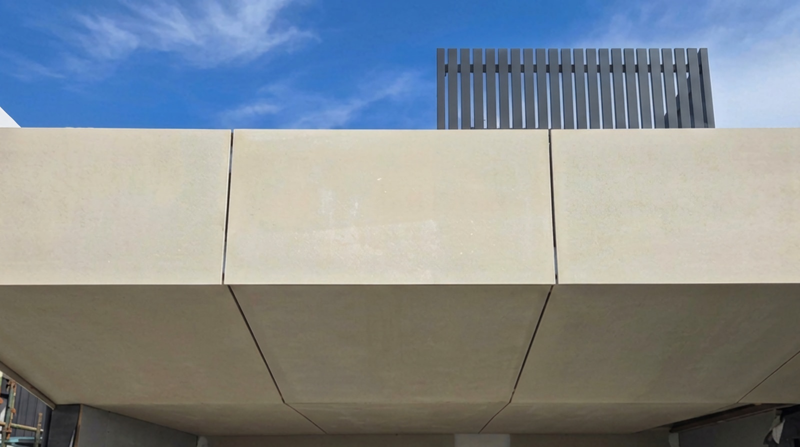 Clean James Hardie Matrix expressed joints aligned across fascia and soffit panels below an aluminium batten screen