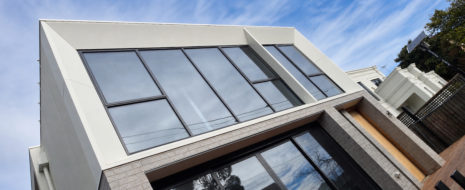 James Hardie Matrix expressed-panel cladding framing large black windows on a completed Melbourne facade
