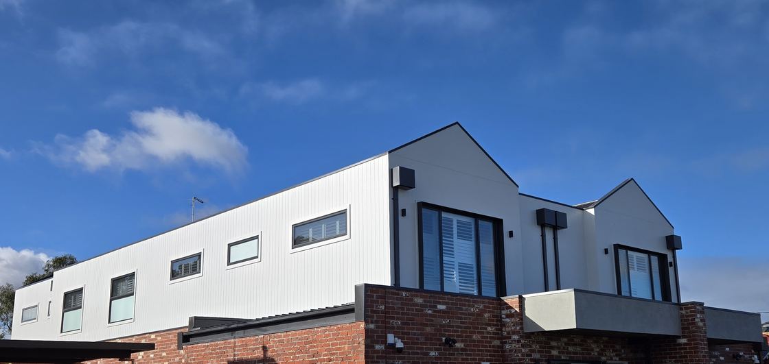 James Hardie Axon cladding installed above recycled brick on a townhouse facade