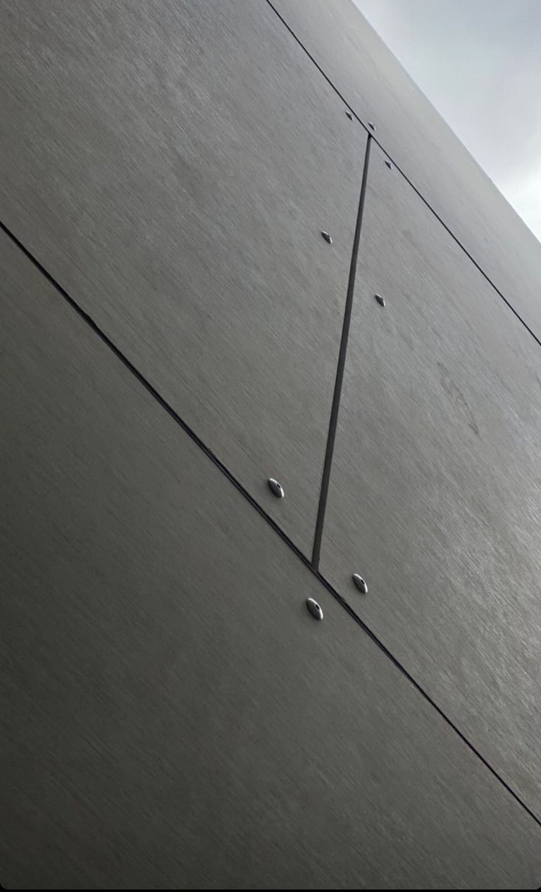 Close-up of Cemintel BareStone expressed fibre cement cladding panels with visible fixings