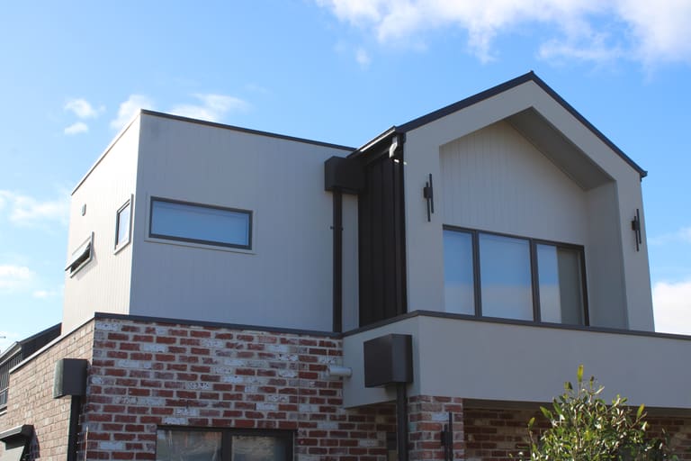 Grey panel gable over recycled brick